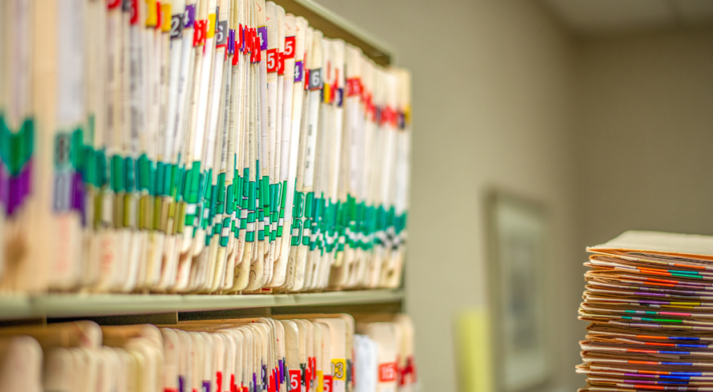 A long list of medical records is spread out, emphasizing the depth of documentation needed for a VA disability claim. The image highlights the importance of comprehensive medical evidence in proving a service connection for conditions like Fournier’s gangrene. Detailed records, including diagnoses, treatment history, and expert opinions, play a crucial role in securing VA benefits and ensuring fair evaluation of a veteran’s disability claim.