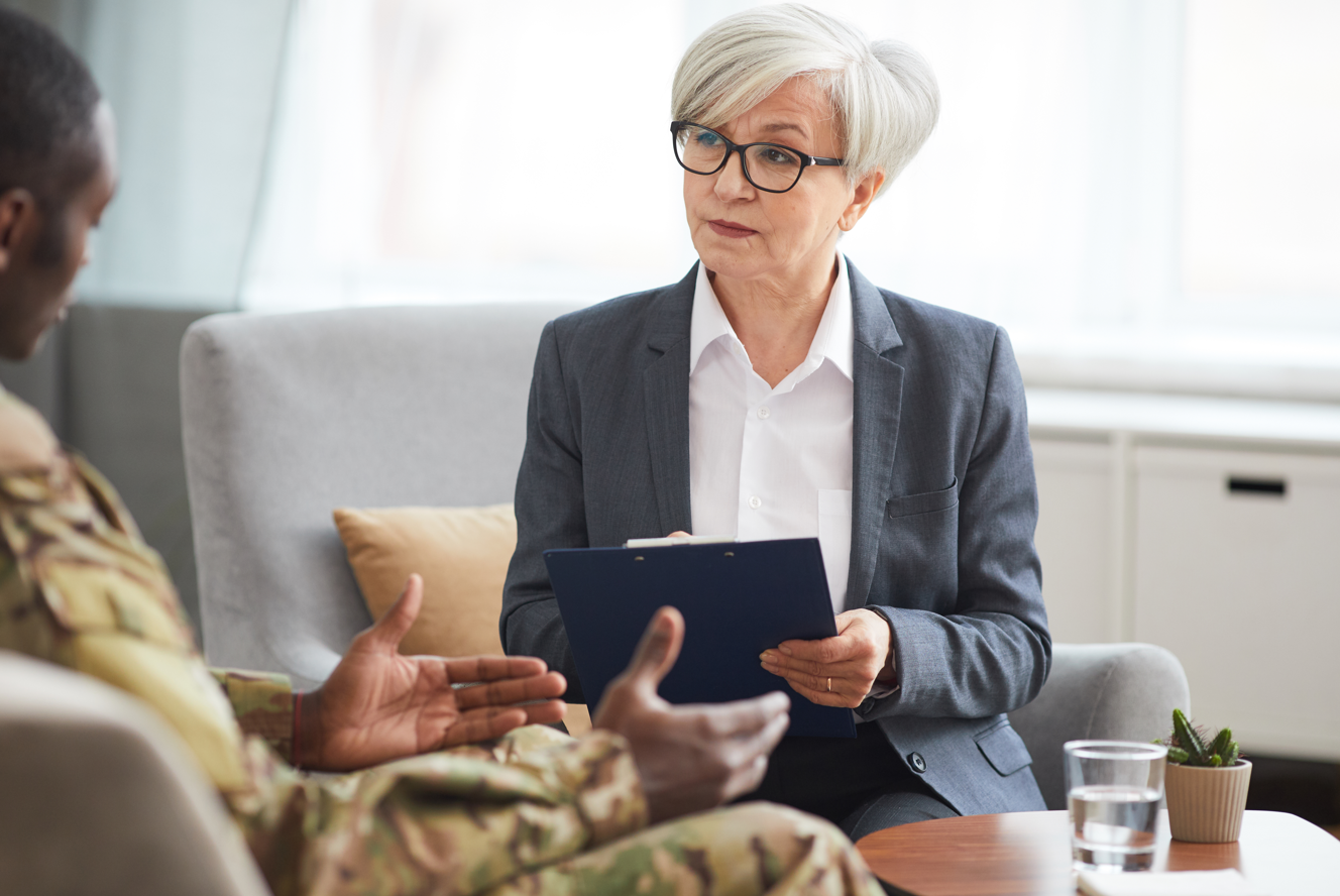 Veteran meeting with a lawyer or VSO representative for legal assistance with a VA disability claim. 