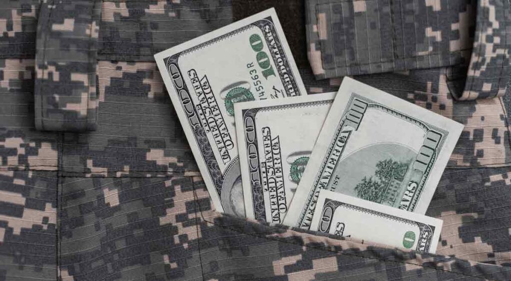 A veteran holding money symbolizes the enhanced education benefits supporting their academic and career goals.