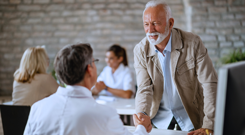 A veteran shakes hands with a doctor after a consultation, discussing his eligibility for a VA pension due to a non-service-connected disability. While his condition isn’t service-related, he may still qualify for financial assistance and healthcare based on his service history and financial need.