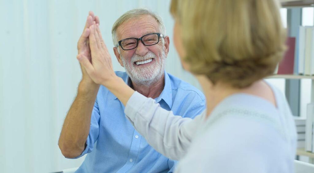 Celebrating a successful VA claim can be a joyful moment. This guide provides helpful tips to navigate the process, so you too can enjoy victories like this couple, celebrating with a well-earned high five.