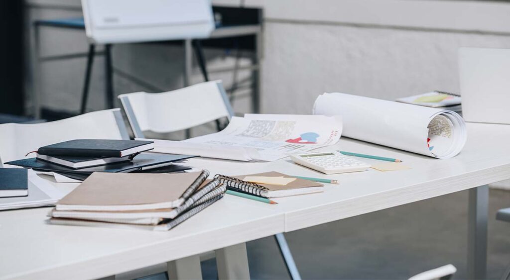 Documents and notebooks on the table reflect the careful preparation and evidence gathering needed when seeking an increased rating. Every detail matters in building a strong, well-documented case.
