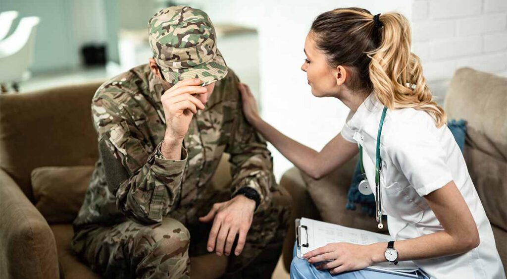 doctor comforting a military man reflects the vital support needed for MST-related PTSD claims. Medical evidence is key to securing the VA benefits veterans deserve.
