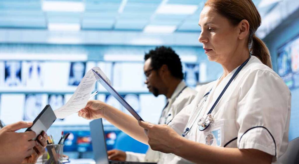 Doctors meeting over healthcare records shows the teamwork behind gathering strong medical evidence — a key part of building a successful VA claim.